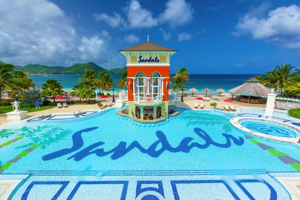 A Main Pools of Sandals With Logo on the Pool