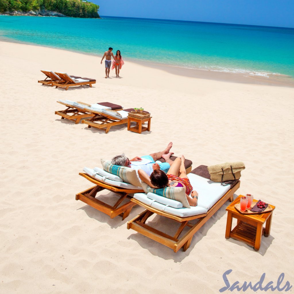 A Clear Sand Beach With a Group of People